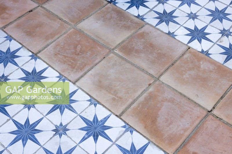 Close up view of patio surface with glazed and terracotta tiles