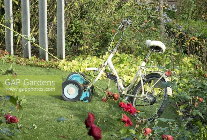 Cycle mower on artificial grass.