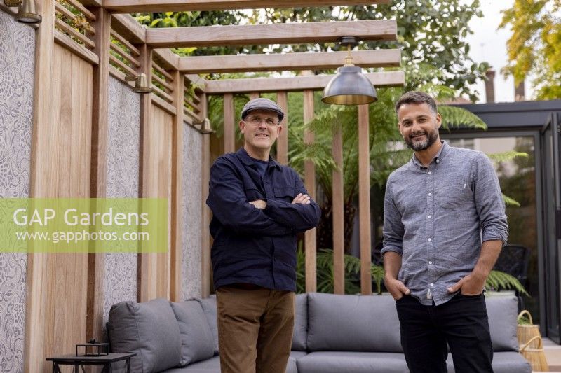 Designers Nick Gough and Douglas Vieira standing in a contemporary garden they have designed
