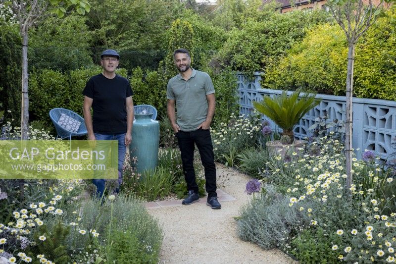 Designers Nick Gough and Douglas Vieira standing in a contemporary garden they have designed