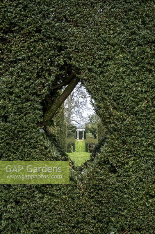 Formal gardens with Yew hedging and small 'peephole' for viewing garden beyond