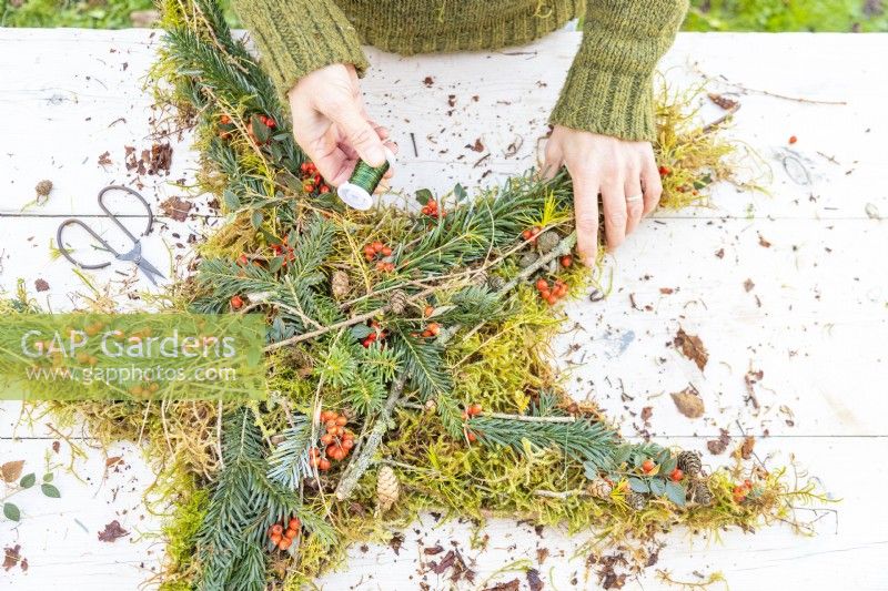 Woman wrapping wire around the wreath