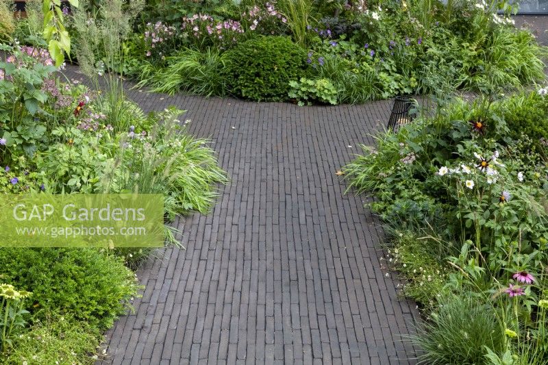Brick pavior paths lead between borders, RHS Chelsea Flower Show 2021, Florence Nightingale Garden