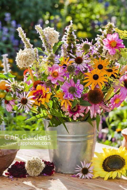 Summer flower bouquet in metal bucket including Echinacea, Monarda, Rudbeckia, Agastache, Dahlia, Allium and Nepeta kubanica.