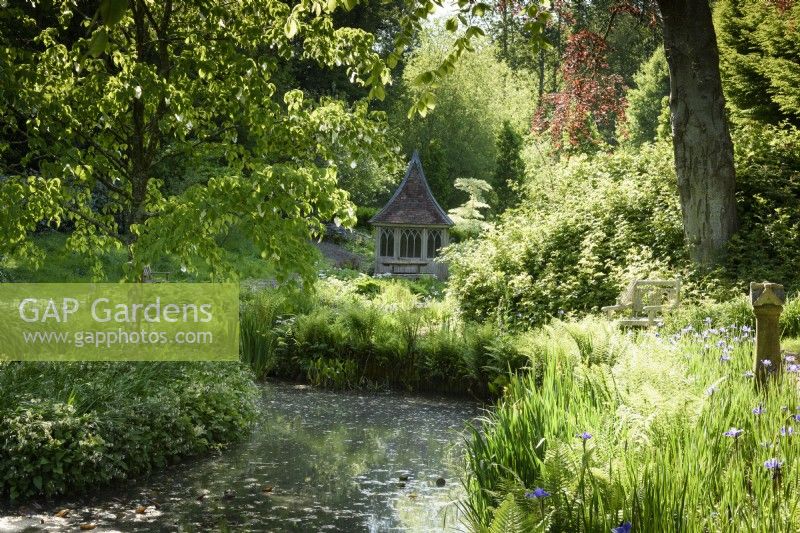 View across a pond to a summerhouse at the Old Rectory, Netherbury, Dorset in May 