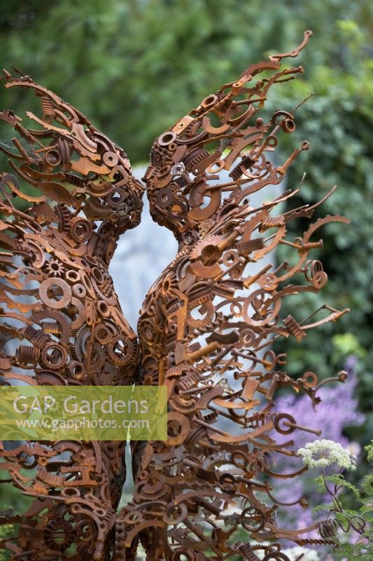 Rusty sculpture of male and female by Penny Hardy. Chelsea Flower Show 2021.