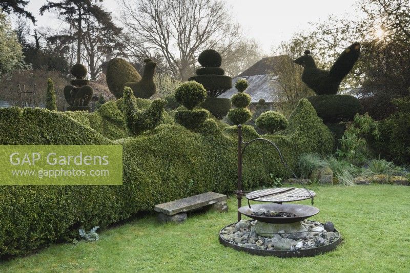 Unusual barbecue in the topiary garden at Balmoral Cottage, Kent in April.