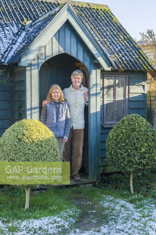 Fiona and Howard Rice standing in the porch of their garden workshop/studio. January