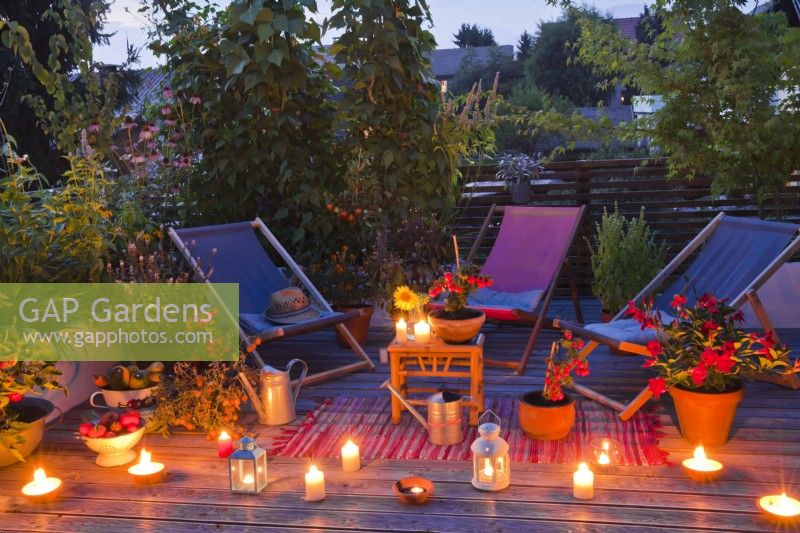 Roof terrace with candles and lantern in the evening.