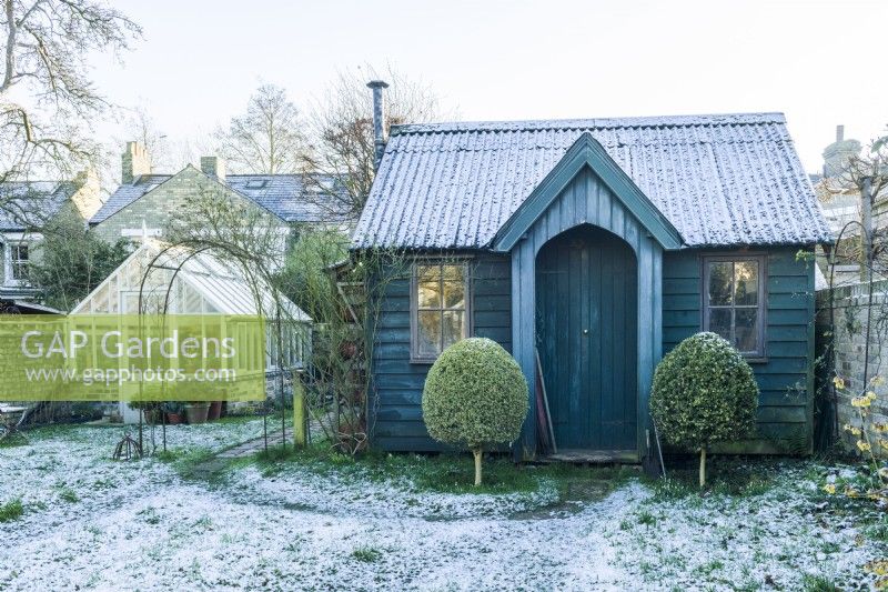 Period style garden studio/workshop and greenhouse in winter.