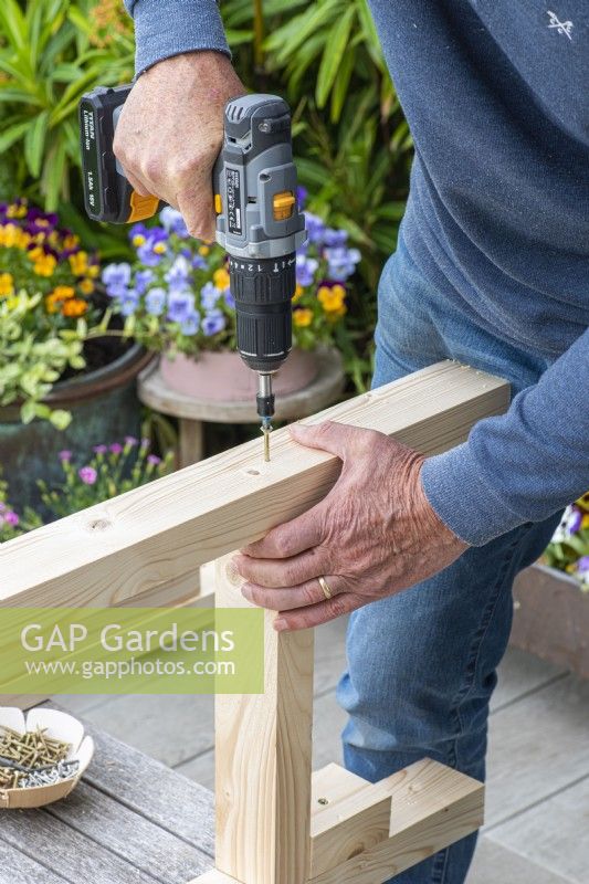 Step-by-Step Making a Potting Bench. Step 5: attach legs to support pieces that hold the bottom shelf in place