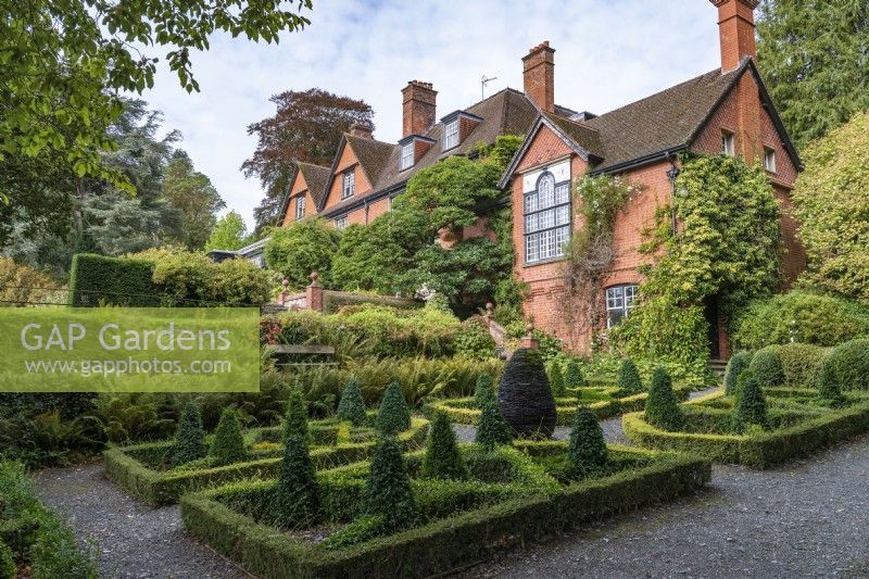Hergest Croft, an Arts and Crafts style house build in 1895, overlooks the Slate Garden, a formal parterre clipped from five species of box, arranged around a sculpture of a fir cone made by Joe Smith.