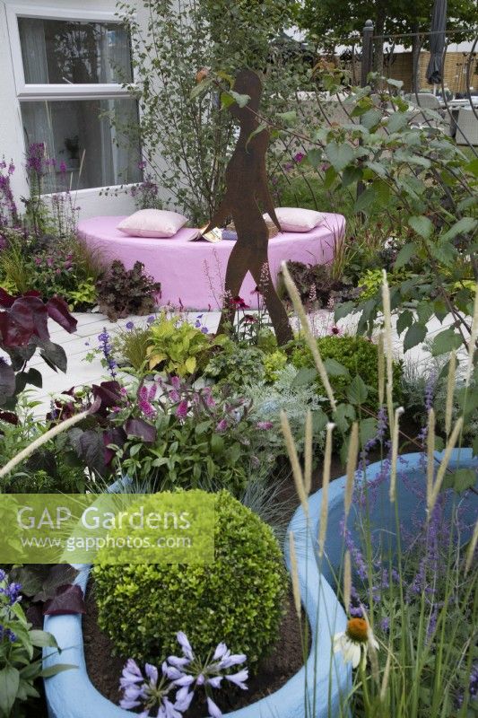 'The Lillian Prime Trust Garden' - BBC Gardener's World Live 2021 - curved pastel blue border with topiary