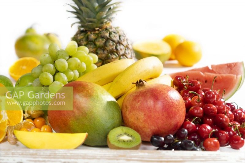 Fruit mix with grapes, mango, bananas and pomegranate, summer June 