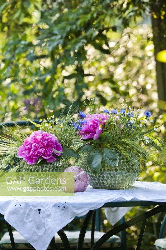 Floral arrangements with peonies, wildflowers and wheat ears.