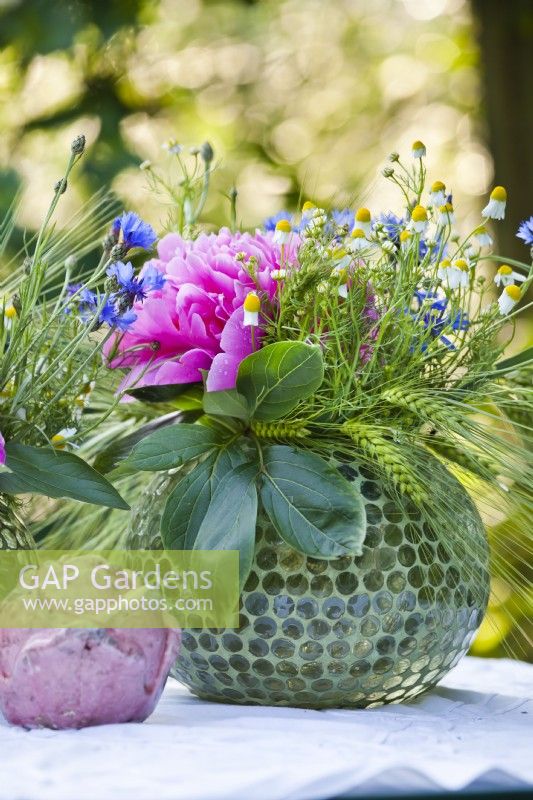 Floral arrangements with peonies, wildflowers and wheat ears.