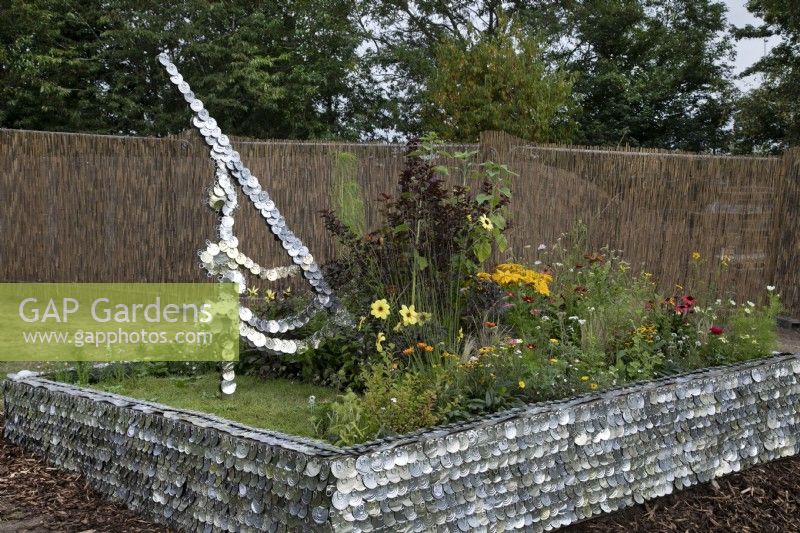 'Carpe Diem' at BBC Gardener's World Live - sundial made from old tin can lids representing solar power