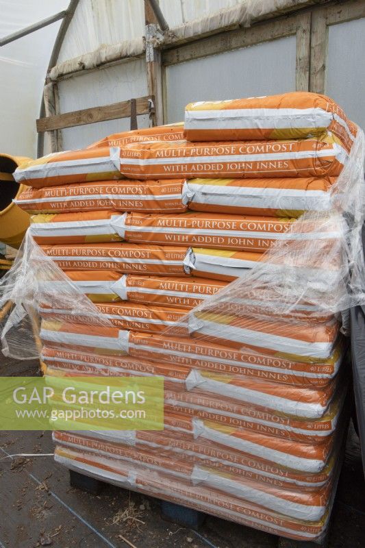 A pallet of multi purpose compost in a poly tunnel. Commercial nursery. Spring. 