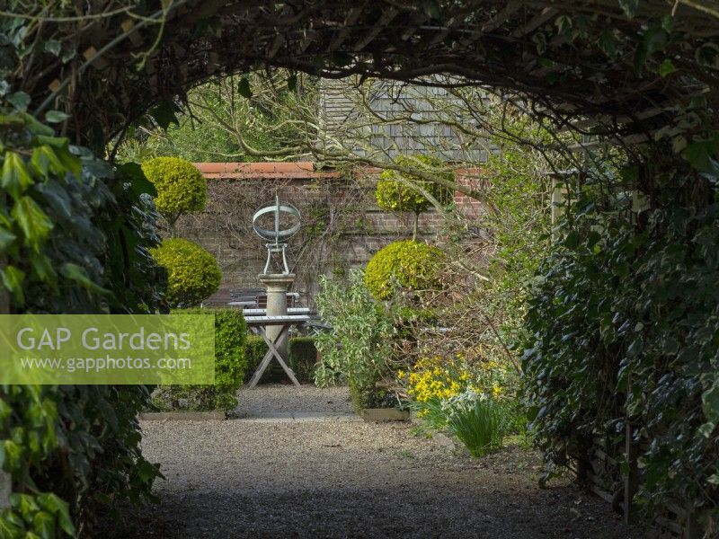 Armillary Sun Dial  and topiary in the tea garden at - East Ruston Old Vicarage, Norfolk.