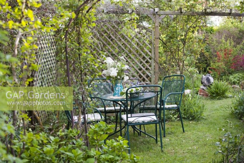Garden furniture with floral arrangement.