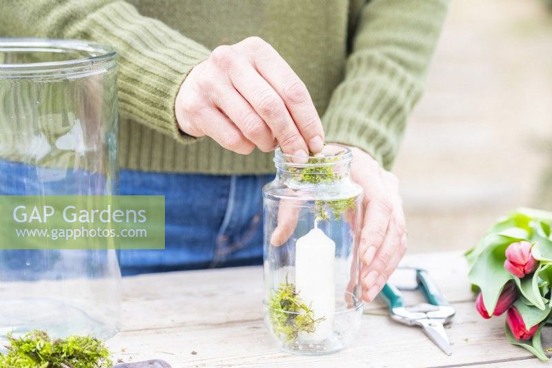Woman placing moss around the base of the candle