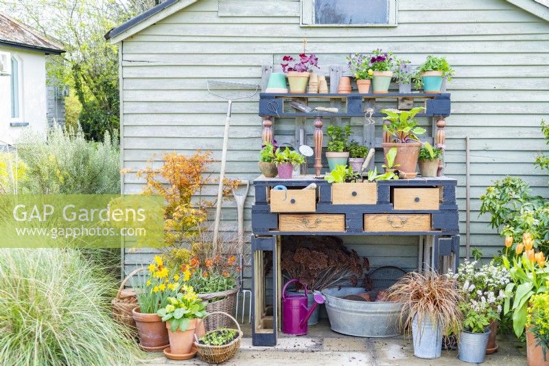 Pallet potting bench with tools and plants