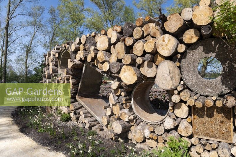 Almere The Netherlands 19th April 2022
Floriade Expo 2022. A ten-yearly botanical garden festival and exhibition, this year taking place in Almere, Flevoland. 
Wall made of materials left from the construction industry and logs from fallen trees 