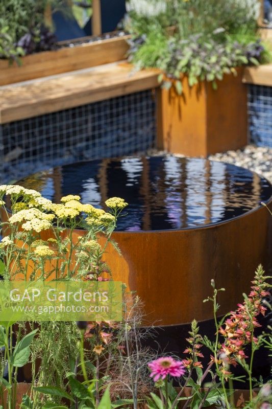 Corten steel water feature.  The Fashion Footprint Garden, RHS Hampton Court Palace Garden Festival 2021