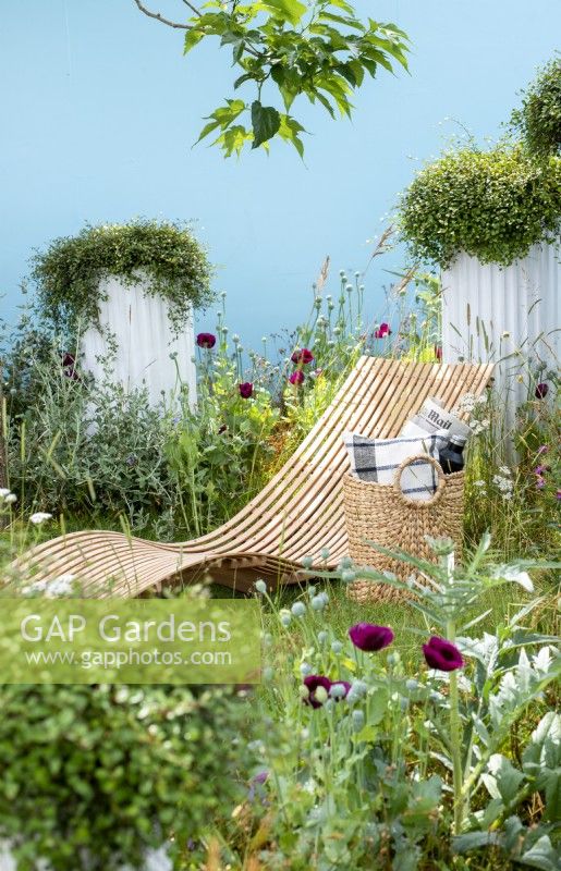 Curved reclining chair. Garden of Solitude, RHS Hampton Court Palace Garden Festival 2021.  Design: Carlotta Montefoschi, Niccolo Cau, Ricardo Walker Campos.  Sponsor: Laboratorio S. Rocco
