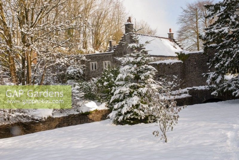 View to The Gardener's Cottage through snow covered trees - Ston Easton Park, Somerset