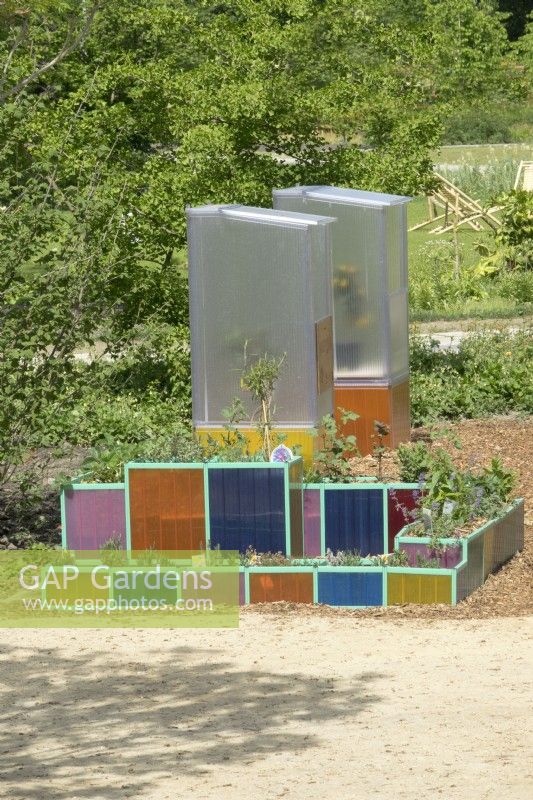 Modern colourful transparant plant containers and greenhouses.