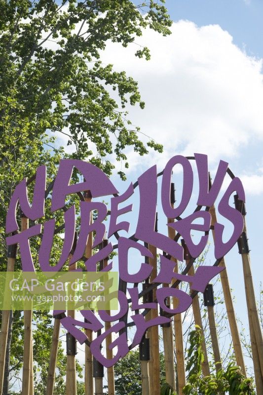 Purple graphic sign made of wood: 