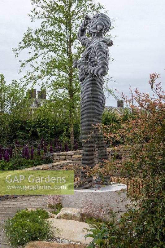 Stainless steel sculpture of an RAF pilot surrounded by a dry stone wall - The RAF Benevolent Fund Garden, RHS Chelsea Flower Show 2022 - Silver Medal