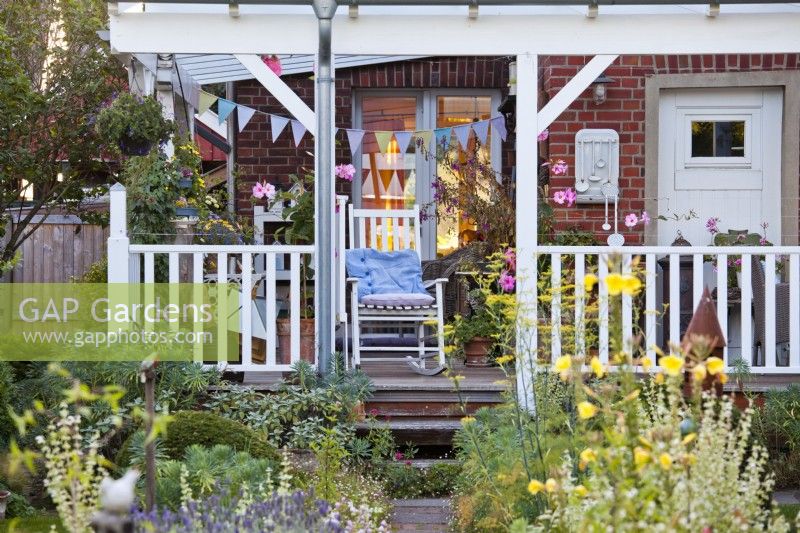 Porch with swing chair and buntings.