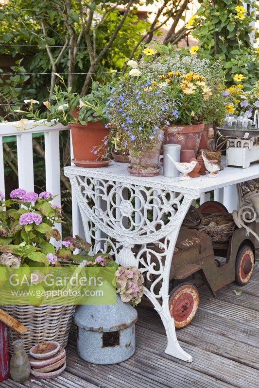 Outdoor decoration on patio with metal table and pottery.
