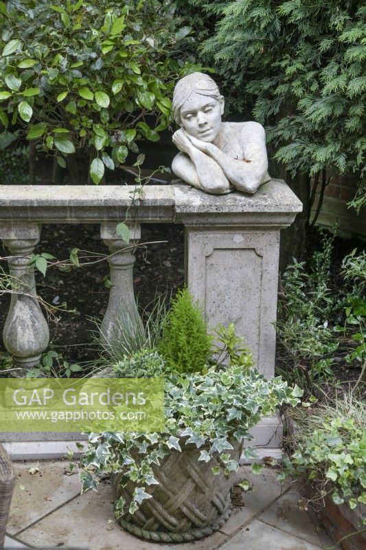 Seja a limestone female bust on balustrade at Hamilton House garden in May 