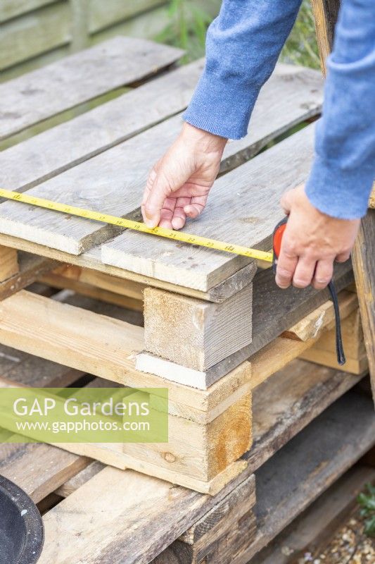 Woman measuring width of the pallet