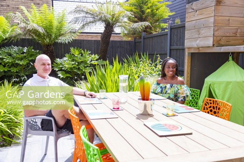 Garden owners sitting at dining area