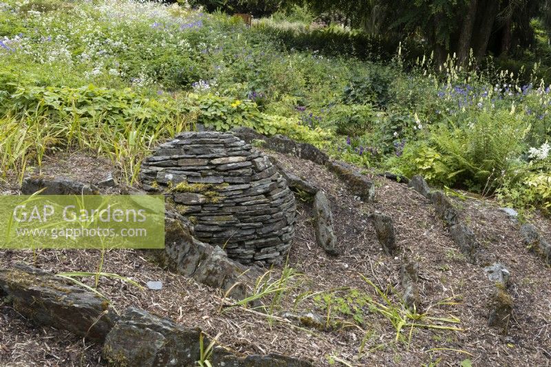 A sculptural installation designed to look like a crashed meteor. The Garden House, Yelverton, Devon. Summer. 