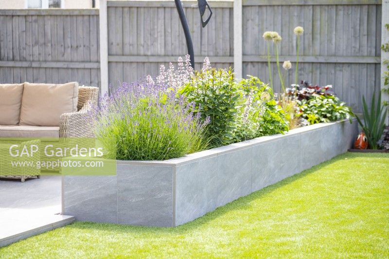 Raised bed separating lawn and seating area