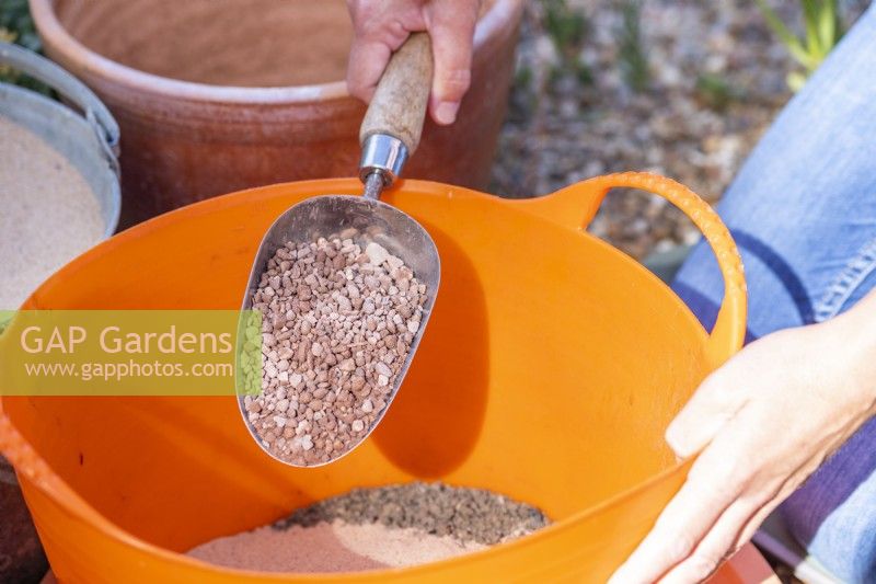 Woman putting gravel in the trug