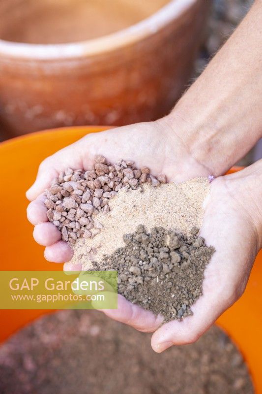 Woman holding gravel, sand and compost in hands