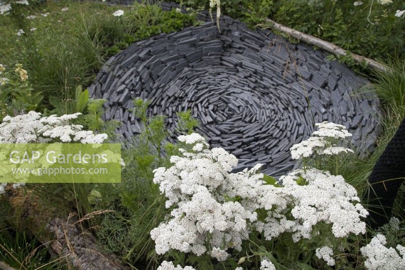 Circular slate dip in the Connections garden at RHS Hampton Court Palace Garden Festival 2022