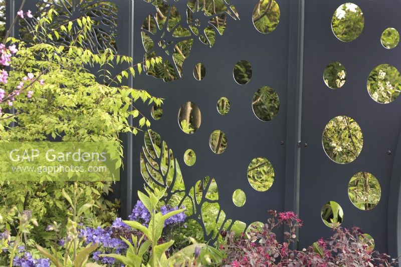 Metal screen with cut outs in the CRUK Legacy Garden at RHS Malvern Spring Festival 2022