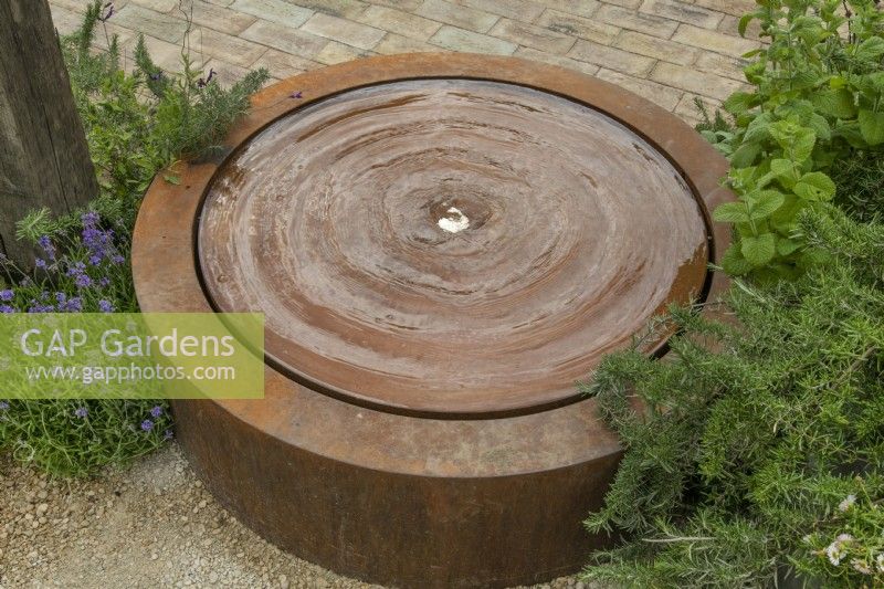 Circular water feature in The Vitamin G Garden at RHS Hampton Court Palace Garden Festival 2022