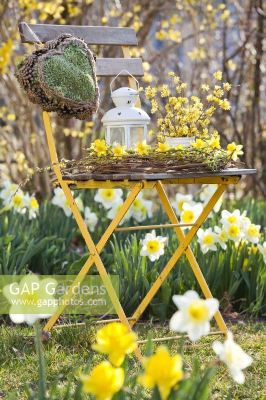 Yellow themed arrangement with daffodils and wreath of willow twigs.