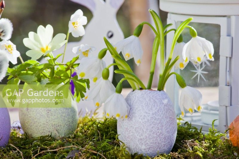 Easter arrangement with egg shell and snowflakes.