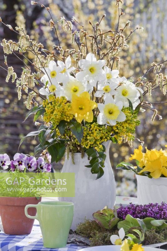 Spring arrangement with daffodils, pansies and mahonia.