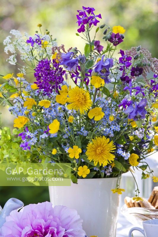 Flower bouquet with dandelion, forget me nots, honesty and buttercup.