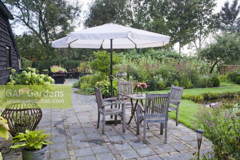 Paved patio with garden furniture.